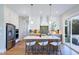 Well-lit kitchen with white cabinets, a central island with seating, and stainless steel appliances at 361 Murray Grey Ln, Wake Forest, NC 27587