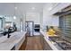 Bright, open kitchen with stainless steel appliances, a large island, and stylish fixtures at 361 Murray Grey Ln, Wake Forest, NC 27587