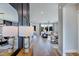 Open-concept living room with hardwood floors, modern decor, and a view of the dining room and kitchen at 361 Murray Grey Ln, Wake Forest, NC 27587