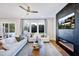 Inviting living room with white couches, a marble fireplace feature, and view of treed outdoor space at 361 Murray Grey Ln, Wake Forest, NC 27587