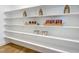 Well-organized pantry with open shelving, ample storage space, and hardwood floors at 361 Murray Grey Ln, Wake Forest, NC 27587