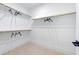 Spacious walk-in closet with carpeted floor, wooden shelving and a black door handle at 361 Murray Grey Ln, Wake Forest, NC 27587
