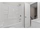 Clean bathroom featuring a white tub/shower combination, a door to the staircase, and a marble vanity at 3700 Summer Pl, Raleigh, NC 27604