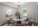 Modern dining room with a round marble table, stylish chairs, and elegant lighting fixture at 3700 Summer Pl, Raleigh, NC 27604