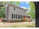 Attractive two-story home featuring gray siding, a red front door, and a green lawn at 3700 Summer Pl, Raleigh, NC 27604