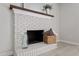 Bright brick fireplace with wooden beam mantel, decorative accents, and neutral tones throughout the room at 3700 Summer Pl, Raleigh, NC 27604