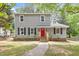 Charming two-story home with gray siding, black shutters, and a bright red front door at 3700 Summer Pl, Raleigh, NC 27604