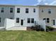 Townhome backyard view of green grass, fence, patio, and landscaping at 377 Thompson Overlook Way, Smithfield, NC 27577