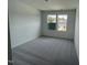 Bright bedroom with plush gray carpeting, two windows, and neutral wall paint at 377 Thompson Overlook Way, Smithfield, NC 27577