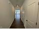 Hallway features hardwood floors and neutral paint, leading to a bright, open living space at 377 Thompson Overlook Way, Smithfield, NC 27577