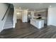 Open-concept kitchen with an island, stainless steel appliances, and gray cabinets at 377 Thompson Overlook Way, Smithfield, NC 27577