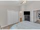 Neutral bedroom features double door closet, tv, and view into bathroom and hallway at 3806 Bison Hill Ln, Raleigh, NC 27604