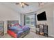 Fun bedroom with a full size bed, a mounted television and a well-lit window at 3806 Bison Hill Ln, Raleigh, NC 27604