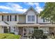 Charming townhome featuring a stone facade and manicured landscaping at 3806 Bison Hill Ln, Raleigh, NC 27604