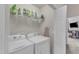 Functional laundry room includes a washer, dryer, and shelving for storage solutions at 3806 Bison Hill Ln, Raleigh, NC 27604