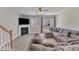 Inviting living room features a cozy fireplace, plush sectional sofa, and access to the backyard at 3806 Bison Hill Ln, Raleigh, NC 27604