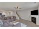 Open-concept living room boasts a fireplace, staircase, and comfortable seating area for relaxation at 3806 Bison Hill Ln, Raleigh, NC 27604