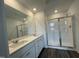 Bathroom with double sink vanity and glass-enclosed shower at 381 Thompson Overlook Way, Smithfield, NC 27577