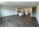 Spacious living room with hardwood floors adjacent to the kitchen area at 381 Thompson Overlook Way, Smithfield, NC 27577