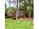 Charming brick two-story home with a well-manicured lawn and mature landscaping at 404 Versailles Dr, Cary, NC 27511