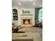 Cozy living room featuring a marble fireplace and an adjacent built-in bookcase at 404 Versailles Dr, Cary, NC 27511