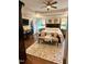 Main bedroom with a tray ceiling, dark wood furniture, and en-suite closet at 404 Versailles Dr, Cary, NC 27511