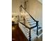 Staircase featuring hardwood floors, white painted steps, and a black railing at 404 Versailles Dr, Cary, NC 27511