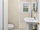 Well-lit bathroom with a pedestal sink, neutral walls, and a shower at 4048 B S Nc 62 Hwy, Burlington, NC 27215