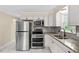Well-lit kitchen featuring stainless steel appliances, granite counters, and white cabinetry at 4048 B S Nc 62 Hwy, Burlington, NC 27215