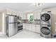 Modern kitchen featuring stainless steel appliances, white cabinets and tile flooring at 4048 B S Nc 62 Hwy, Burlington, NC 27215