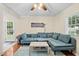 Spacious living room featuring a large sofa, hardwood floors, and ample natural light at 4048 B S Nc 62 Hwy, Burlington, NC 27215