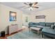 Open living room with hardwood flooring, stylish decor, and a large sofa at 4048 B S Nc 62 Hwy, Burlington, NC 27215