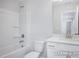 Bathroom featuring a shower-tub combo and vanity with quartz countertop at 436 Longleaf Glen Lane, Zebulon, NC 27597