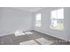 Bright bedroom with carpet flooring and two windows at 436 Longleaf Glen Lane, Zebulon, NC 27597
