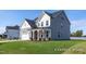 View of the side of a two-story house with gray siding and a well-maintained lawn at 436 Longleaf Glen Lane, Zebulon, NC 27597