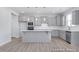 Modern kitchen with gray cabinets, an island, stainless steel appliances, and ample counter space at 436 Longleaf Glen Lane, Zebulon, NC 27597