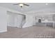 Open living space with stairs, wood floors, and a kitchen area with gray cabinets at 436 Longleaf Glen Lane, Zebulon, NC 27597