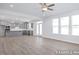 Open concept kitchen and living room area with a ceiling fan and plenty of natural light at 436 Longleaf Glen Lane, Zebulon, NC 27597