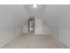 Finished attic space with neutral carpet, and access to other rooms, with two-tone painted walls at 46 Blaze Ridge Dr, Smithfield, NC 27577