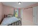 This charming bedroom boasts a metal bed frame, soft bedding, and a window with light blue curtains at 46 Blaze Ridge Dr, Smithfield, NC 27577