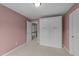 Bedroom showing neutral carpet, walls painted pink, and a large white cabinet against the far wall at 46 Blaze Ridge Dr, Smithfield, NC 27577