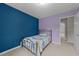 Bedroom with walls painted blue and purple, star ceiling, and a bed with blue patterned comforter at 46 Blaze Ridge Dr, Smithfield, NC 27577