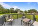 Relaxing deck offers outdoor seating for enjoying the view of the spacious, tree-lined backyard at 46 Blaze Ridge Dr, Smithfield, NC 27577