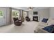 Cozy living room features a fireplace, neutral carpet, and plenty of natural light from large windows at 46 Blaze Ridge Dr, Smithfield, NC 27577