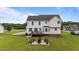 Rear exterior showcasing a deck, patio, and lush backyard, ideal for outdoor enjoyment at 46 Blaze Ridge Dr, Smithfield, NC 27577