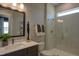Modern bathroom featuring a sleek vanity and a glass-enclosed shower with gold fixtures at 4628 Rogers Rd, Wake Forest, NC 27587