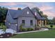 Side view of home with garage and inviting front porch with stylish seating at 4628 Rogers Rd, Wake Forest, NC 27587