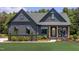 Beautiful home with a welcoming porch, complemented by a green lawn and landscaping at 4628 Rogers Rd, Wake Forest, NC 27587