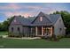 Charming home featuring a covered porch with wooden columns and well-manicured landscaping at 4628 Rogers Rd, Wake Forest, NC 27587
