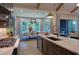 Modern kitchen with gray cabinets, large island with seating, and dining area in the background at 4628 Rogers Rd, Wake Forest, NC 27587